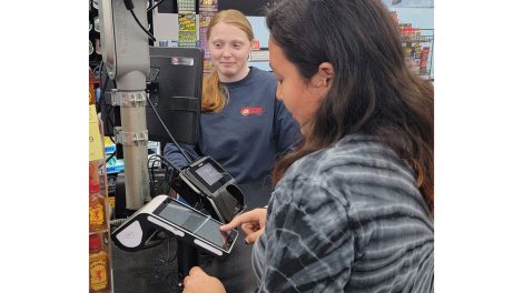 image of customer are register in store served by Laurel Grocery