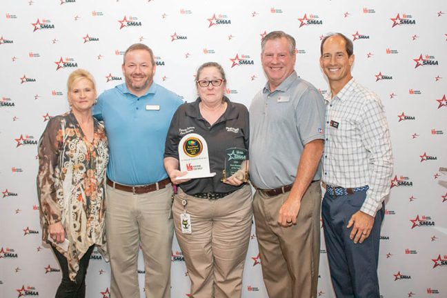 Tammy Peterson, middle, receiving the EIA-MOTY and Community Relations Expert awards.