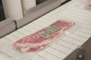 image of Prairie Fresh package of pork on conveyor belt at Seaboard Triumph Foods processing plant