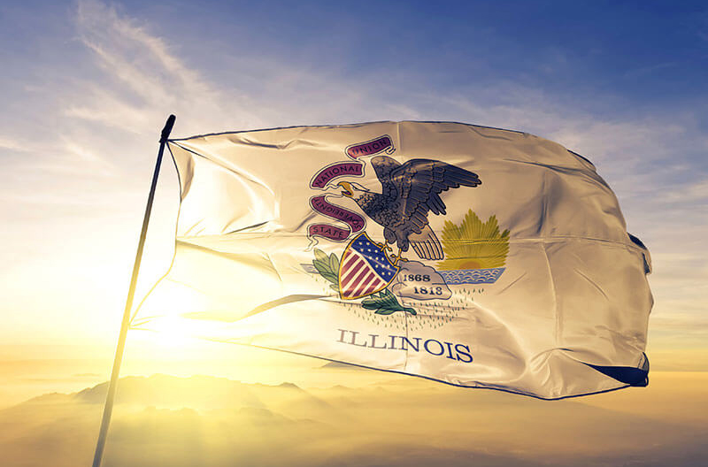 image of Illinois state flag flying with sun behind it