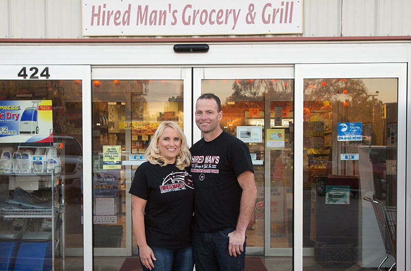 image of Jenny and Clint Osner in front of Hired Man's Grocery