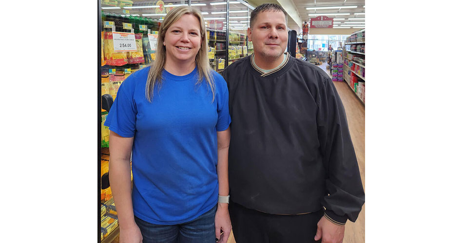 image of Liz and Blake Schwartz standing in aisle at Hometown Market grocery store