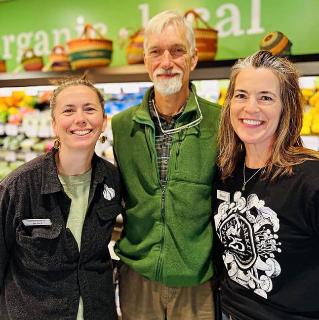 image of Harvest Market Store Manager Staci Breitenbach, co-owner Bob Kleszics and Assistant Manager Cheryl Owen standing in store aisle