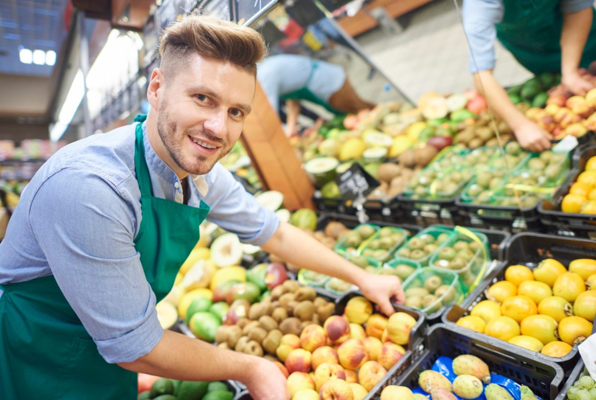 Grocery clerk stocking product