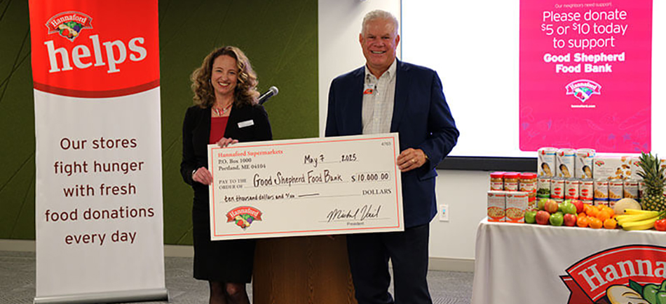 photo of Hannaford Supermarkets president presenting donation to Good Shepher food bank official
