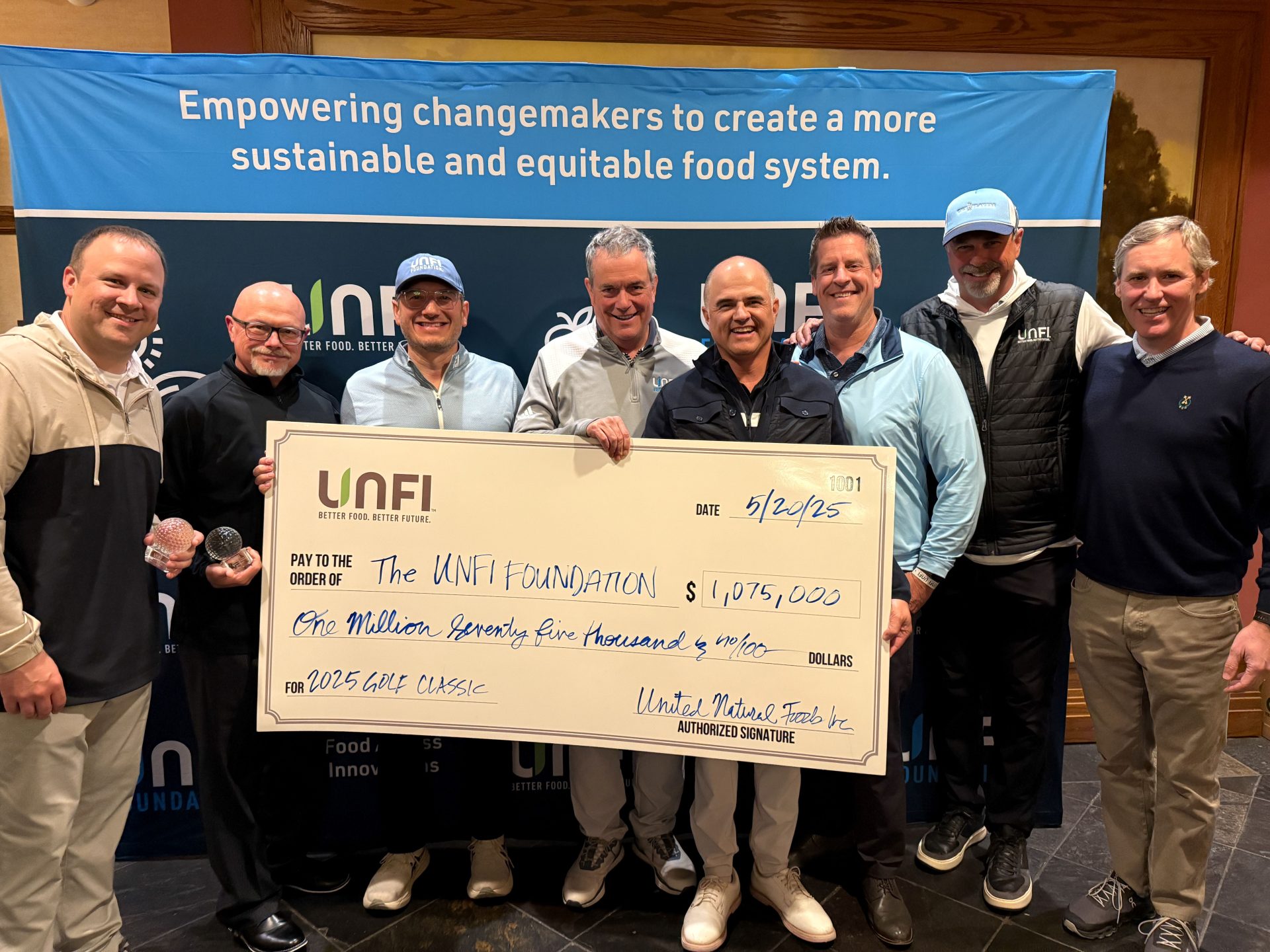Leaders from UNFI and Kellanova, this year’s title sponsor, present a $1,075,000 check to the UNFI Foundation.