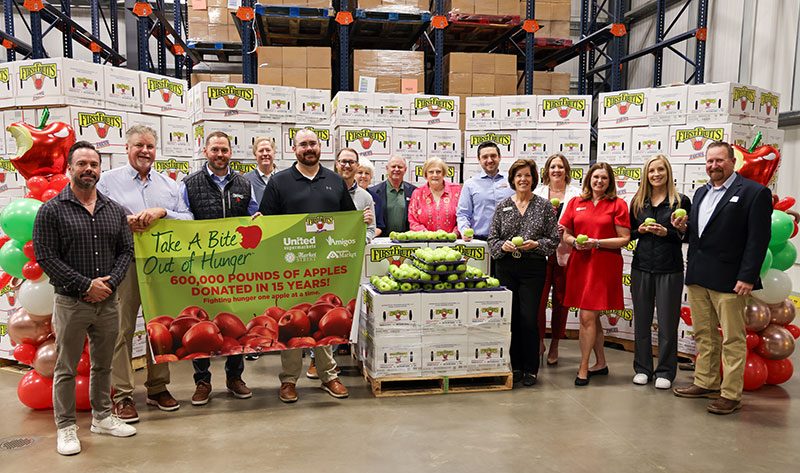 photo of group standing in front of apple bins at The United Family store in Lubbock, Texas