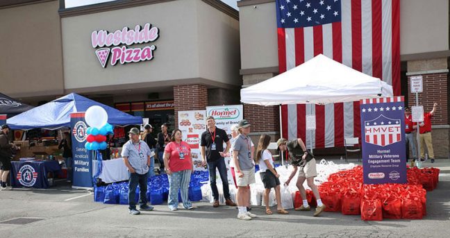 image of volunteers giving groceries to military families at Kent's Market