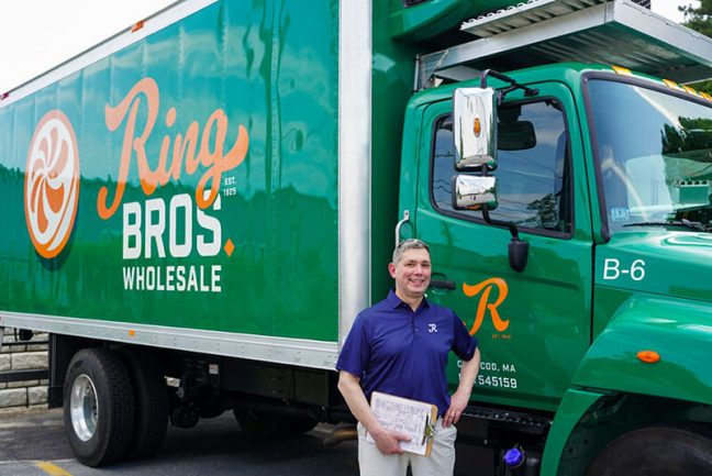 image of Ring Bros. Wholesale GM Rich Mulcahy with a truck featuring the company’s rebranding.