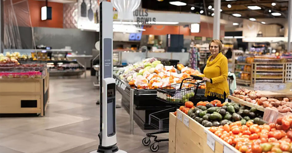 image of lady shopping in DeCicco & Sons produce department where Simbe's Tally robot is scanning