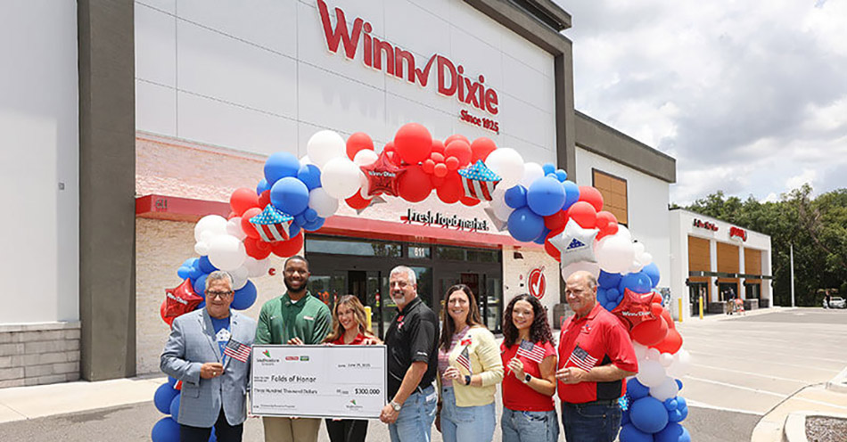 photo of group of people assembled for donation from SEG to Folds of Honor standing in front of a Winn-Dixie store