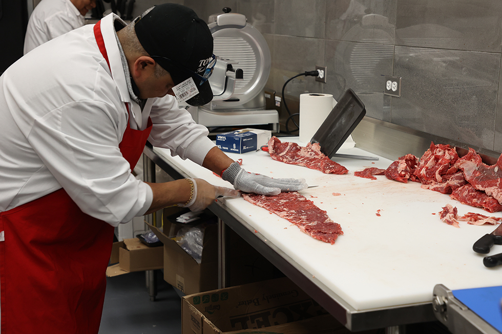 Meat cutter at Tony's Fresh Market
