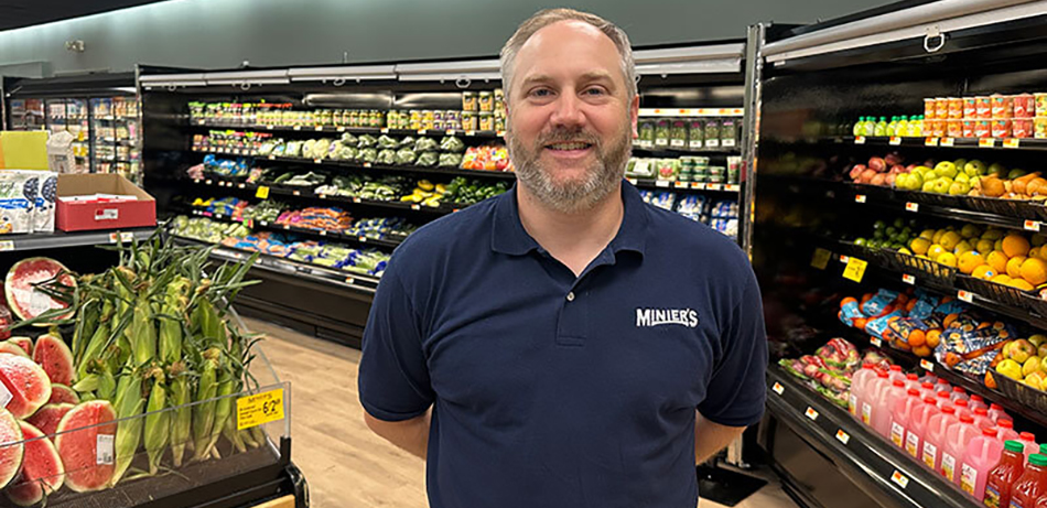 image of Paul Minier standing in produce department in Minier's grocery store in Big Flats, NY