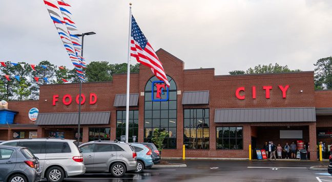 image of Food City storefront with flag flying in foreground
