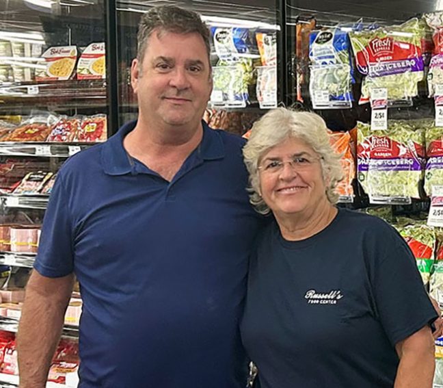 photo of Russell’s CEO Melanie Robin and her brother, Francis Robin standing in front of refrigerated case