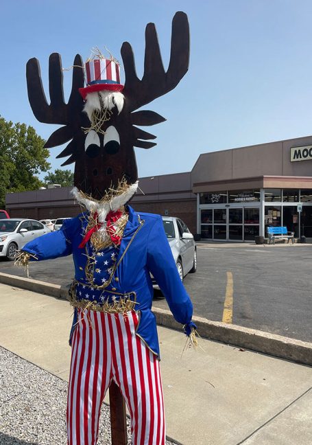 image of scarecrow with a moose's head at Moose's Market decorated for Fourth of July