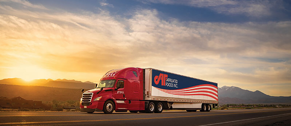 image of AFI truck driving on highway with sunset in background