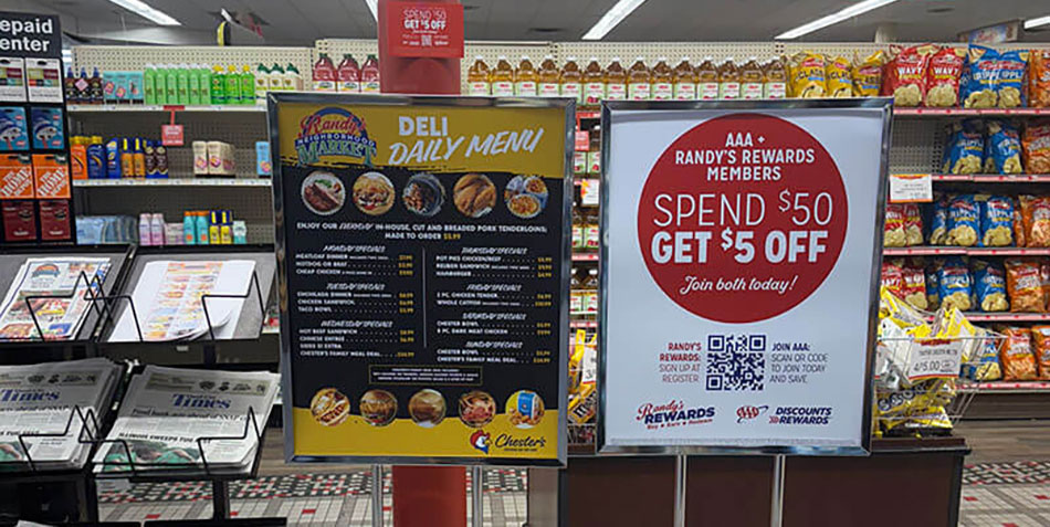 photo of sign in Randy's Neighborhood Market about partnership with AAA