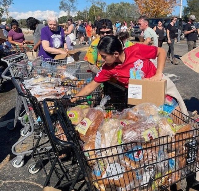photo of shopping carts filled with food and other essentials at Earth Fare food drive following Hurricane Helene