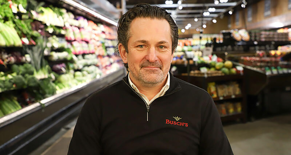 photo of Busch's Fresh Food Market President and CEO Bobby Turner standing in produce department