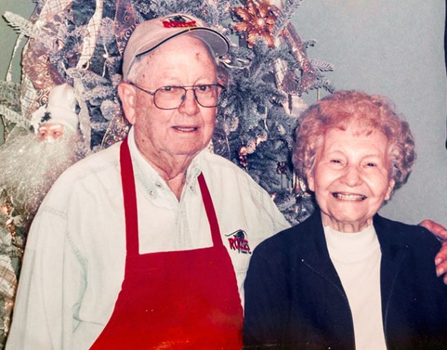 photo of Anthony and Joyce Rouse with Christmas tree in background
