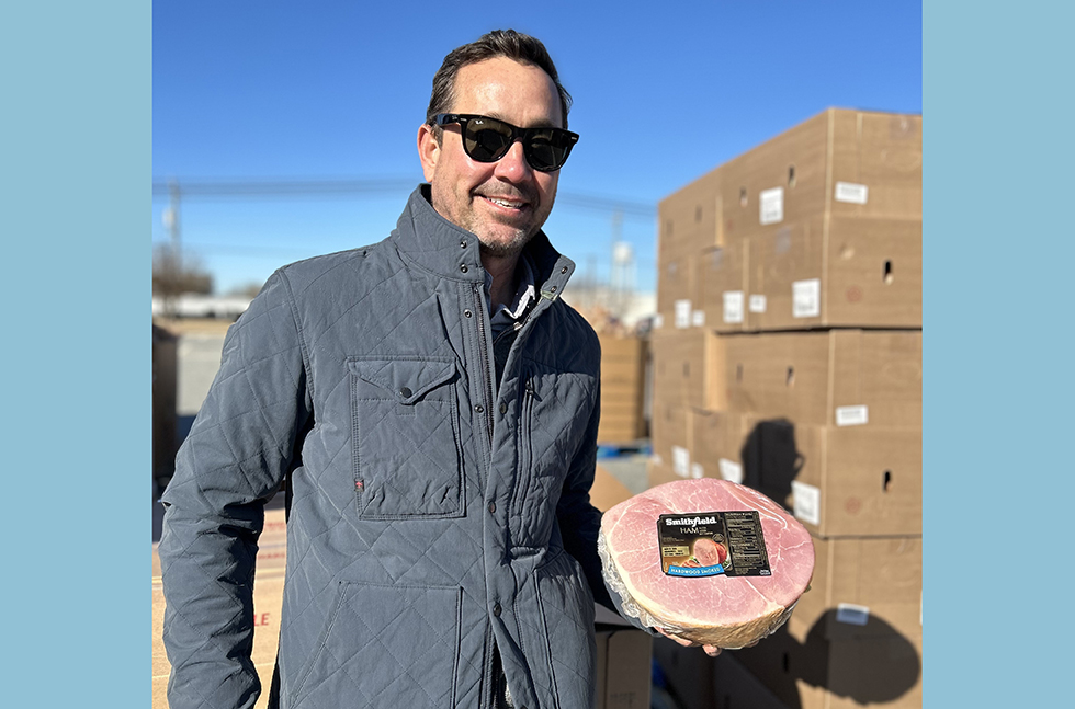 Keller Watts, chief business officer of Smithfield Foods, volunteers at the Season of Serving food distribution event in Smithfield, Virginia.