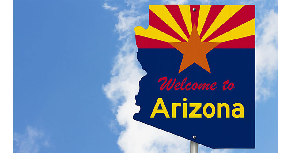Arizona welcome sign with clouds and blue sky in background