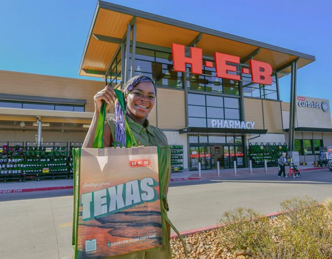 photo of shopper holding H-E-B reusable bag with storefront in background