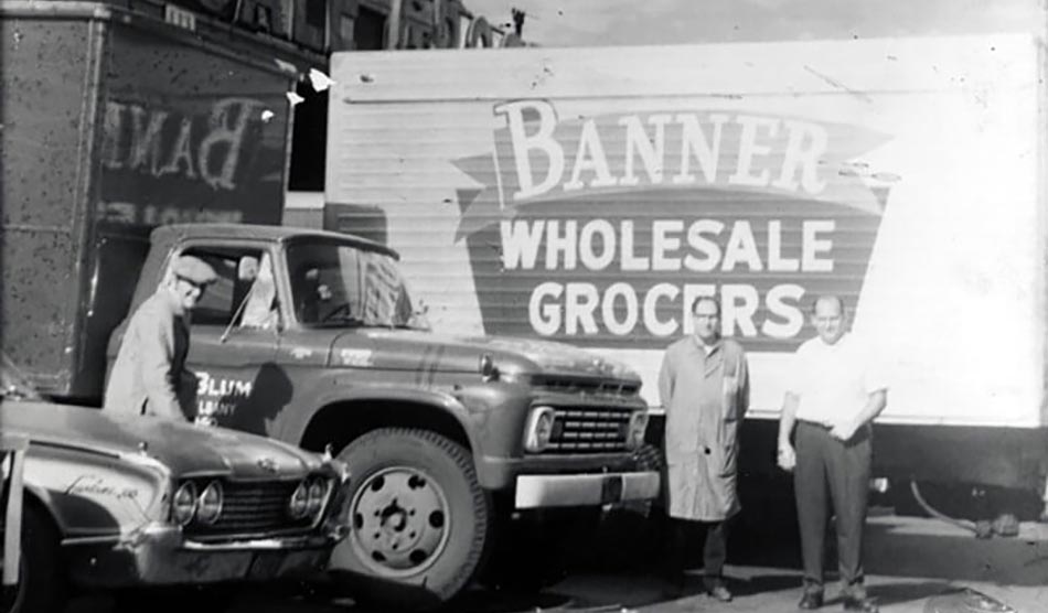 old black-and-white photo of Banner Wholesale Grocers building and truck