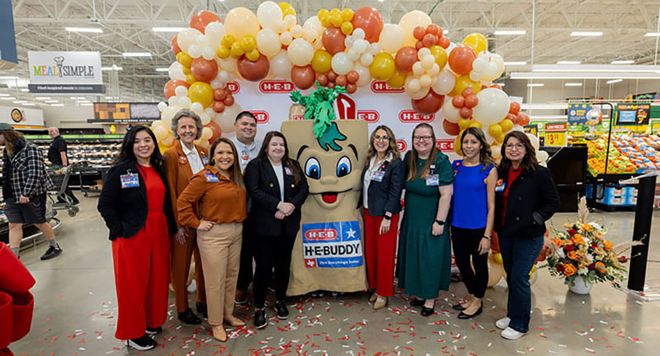 photo of H-E-B employees standing in front of balloons to celebrate remodeled Hancock Center store in Austin