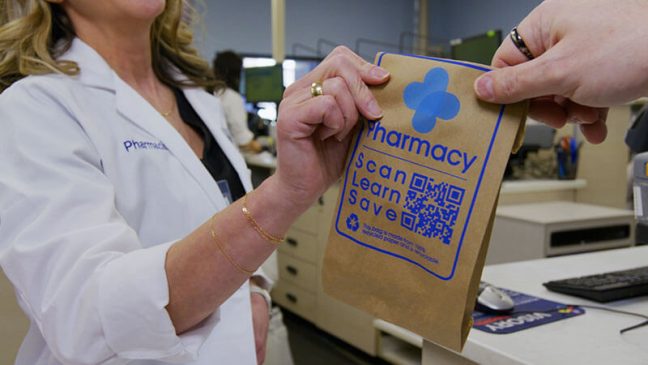 photo of Kroger pharmacy employee with prescription bag