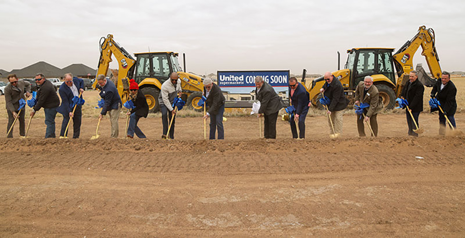 photo of line of people with shovels at groundbreaking event for United Supermarkets in Wolfforth, Texas