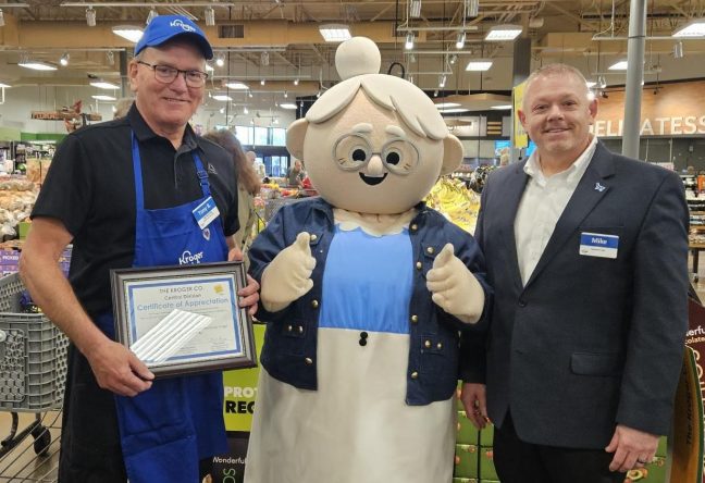 From left to right: Tony Bennett, Kroger Mascot Emma Jean and Division President Mike Goodwin.