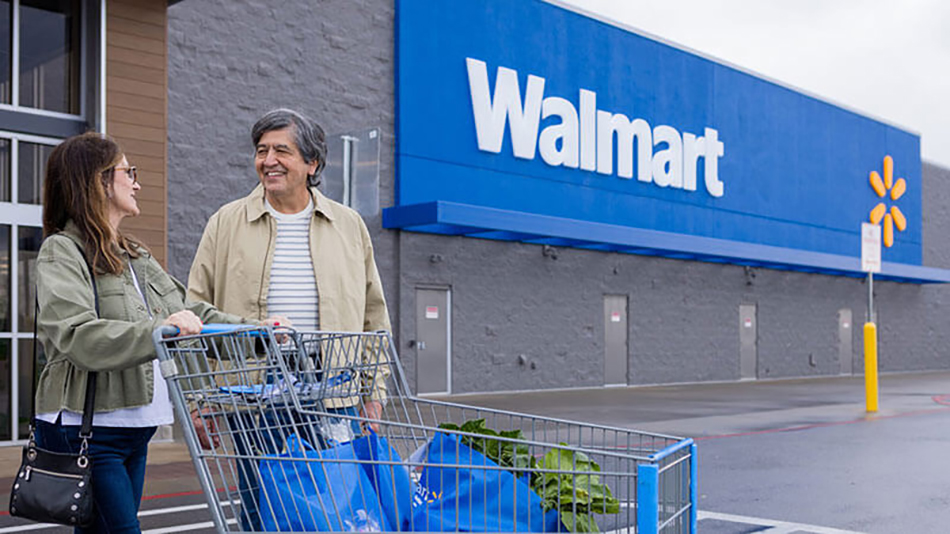 photo of couple standing with shopping cart outside of a Walmart store