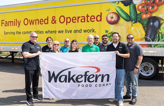 group of Wakefern employees holding sign in front of ShopRite truck