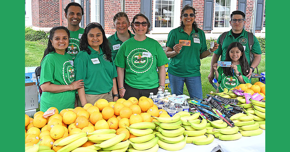 Wakefern and ShopRite employees standing behind table filled with fruit snacks for Special Olympics
