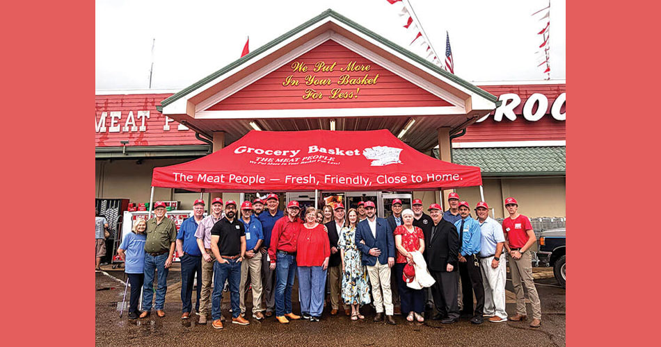 photo of group standing in front of Grocery Basket store