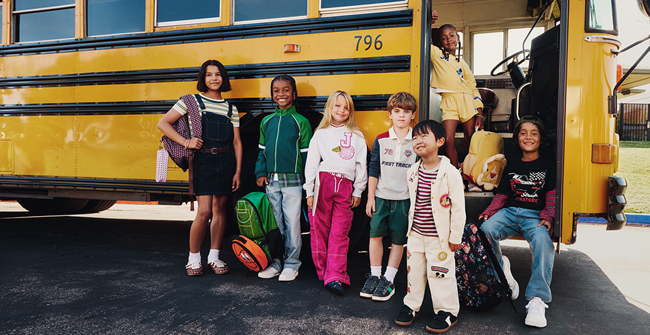 photo of children standing beside school bus for Walmart back to school promotion
