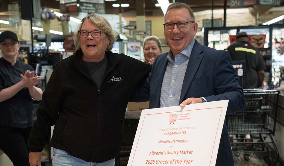 photo of Michelle Harrington receives the surprise notification that she was named Grocer of the Year from WGA President and CEO Mike Semmann