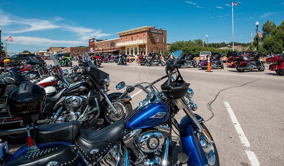 photo of motorcycles parked along both sides of road in downtown Sturgis, SD