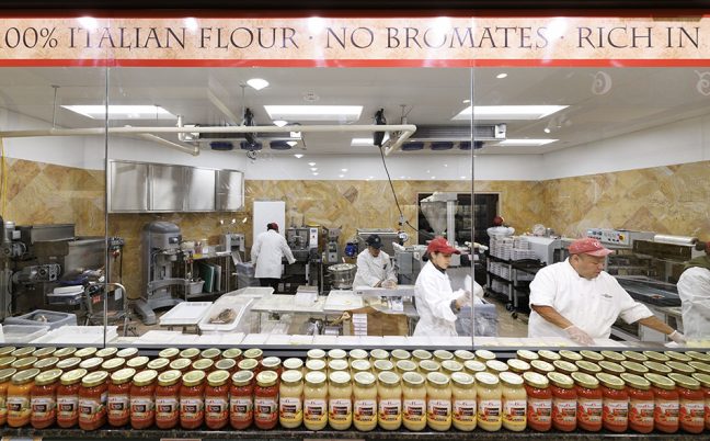 photo of glass window where shoppers at Uncle Giuseppe's can watch pasta makers at work