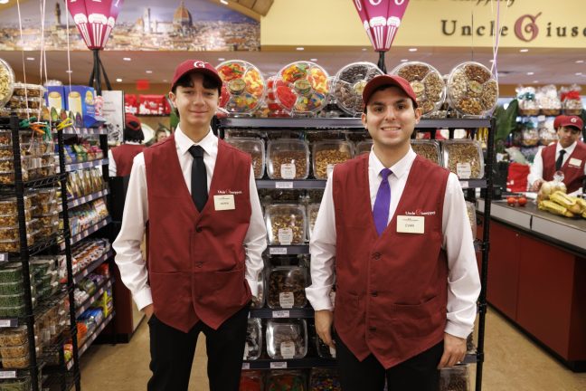 photo of two young men in Uncle Giuseppe's uniforms at new Greenvale store