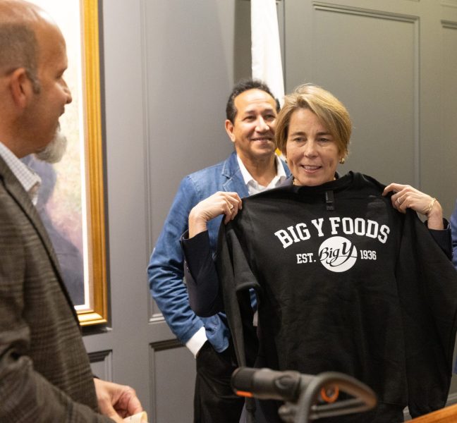 Gov. Maura Healey holding up Big Y sweatshirt
