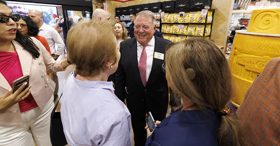 photo of Carl DelPrete, co-founder and CEO of Uncle Giuseppe’s, welcoming shoppers to the company’s new store in Greenvale, New York.