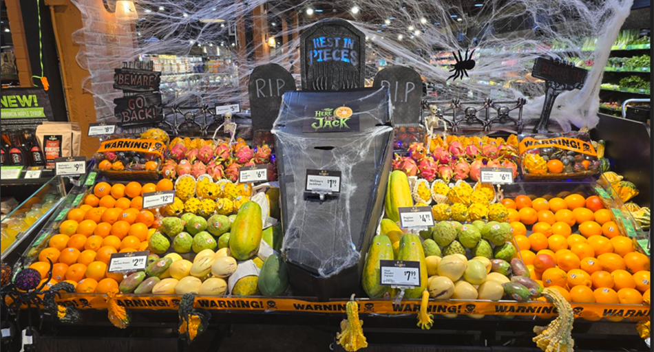 Halloween produce display featuring spider webs and coffin