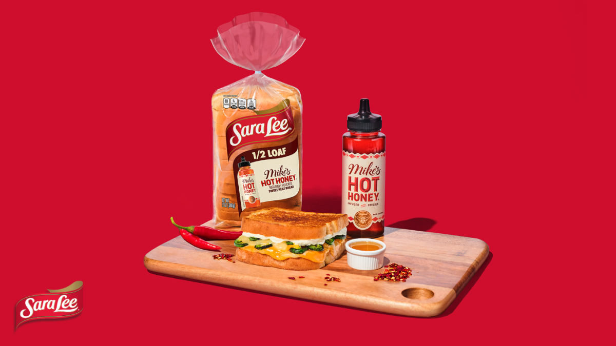Sara Lee hlaf loaf on a cutting board with mikes hot honey and a sandwitch